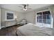 Bright bedroom featuring a ceiling fan, dresser, large window, and sliding door to the outside at 1019 Palmyra Dr, Fort Mill, SC 29708