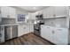 Well-lit kitchen with stainless steel appliances, bright white cabinetry, and modern fixtures at 1019 Palmyra Dr, Tega Cay, SC 29708