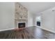 Modern living room featuring a stone fireplace, hardwood floors, and natural light at 1019 Palmyra Dr, Fort Mill, SC 29708