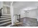 Spacious living room with hardwood floors, staircase, modern chandelier, and plenty of natural light at 1019 Palmyra Dr, Tega Cay, SC 29708