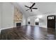 Cozy living room with a stone fireplace, wood floors, and lots of natural light at 1019 Palmyra Dr, Tega Cay, SC 29708