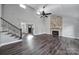 Bright living room featuring vaulted ceilings, stone fireplace, and dark hardwood floors at 1019 Palmyra Dr, Tega Cay, SC 29708