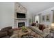 Inviting living room featuring a striking stone fireplace and comfortable furnishings at 1019 Palmyra Dr, Fort Mill, SC 29708