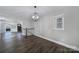 Open living space featuring wood floors, natural light, and modern chandelier at 1019 Palmyra Dr, Fort Mill, SC 29708