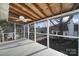 Screened porch with ceiling fan and views of the treed neighborhood at 1019 Palmyra Dr, Tega Cay, SC 29708