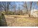 Large backyard with mature trees, shed, and space for outdoor activities at 10718 Downpatrick Pl, Charlotte, NC 28262