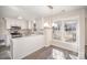 Open eat-in kitchen featuring white cabinets, stainless steel appliances, and a hanging chandelier at 10718 Downpatrick Pl, Charlotte, NC 28262