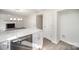 Updated kitchen featuring white cabinets and stainless steel dishwasher, opening to a living area with a fireplace at 10718 Downpatrick Pl, Charlotte, NC 28262