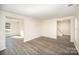 Light filled living room features light gray floors and neutral colored walls at 10718 Downpatrick Pl, Charlotte, NC 28262