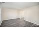 Spacious living room featuring light gray floors, neutral colored walls and white trim at 10718 Downpatrick Pl, Charlotte, NC 28262