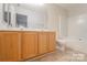 Bright bathroom featuring a double vanity with ample storage and tiled floor at 10946 Garden Oaks Ln, Charlotte, NC 28273