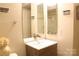 Well-lit bathroom with a modern vanity, mirror, and ample counter space at 10946 Garden Oaks Ln, Charlotte, NC 28273