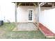 Cozy patio area outside with wood pergola and partial privacy fence, perfect for relaxing or outdoor dining at 10946 Garden Oaks Ln, Charlotte, NC 28273