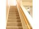 Carpeted staircase with wood railing leading to the second floor at 10946 Garden Oaks Ln, Charlotte, NC 28273