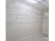 Empty walk-in closet ready to be used with white shelving and neutral walls at 10946 Garden Oaks Ln, Charlotte, NC 28273