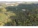 Scenic aerial of land with mixed forest, including a well-maintained pine forest and a small pond at 11001 Mount Holly Hntrsvlle Rd, Huntersville, NC 28078