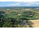 Expansive aerial view of lush, wooded acreage surrounding a well-maintained home at 11001 Mount Holly Hntrsvlle Rd, Huntersville, NC 28078