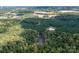 Aerial perspective of land with a pond and dense forestry including Rt 77 in the distance at 11001 Mount Holly Hntrsvlle Rd, Huntersville, NC 28078