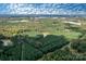 Scenic aerial view of land featuring dense forestry and a small private pond at 11001 Mount Holly Hntrsvlle Rd, Huntersville, NC 28078