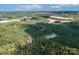 Areal view of land featuring mature trees, a dense pine forest and a private pond at 11001 Mount Holly Hntrsvlle Rd, Huntersville, NC 28078