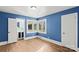 Bright bedroom with hardwood floors and blue walls at 115 E Texas Ave, Bessemer City, NC 28016