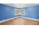 Simple bedroom with hardwood floors and blue walls at 115 E Texas Ave, Bessemer City, NC 28016