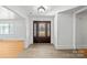 Bright entryway with hardwood floors and a dark brown door at 115 E Texas Ave, Bessemer City, NC 28016