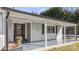 Renovated front porch with gray painted siding and a brown door at 115 E Texas Ave, Bessemer City, NC 28016