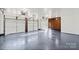 Spacious garage interior with grey epoxy floor at 115 E Texas Ave, Bessemer City, NC 28016