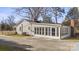 Rear view of house showing sunroom and detached garage at 115 E Texas Ave, Bessemer City, NC 28016