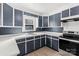 Modern kitchen featuring dark blue cabinets and white countertops at 115 E Texas Ave, Bessemer City, NC 28016