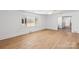 Hardwood floors and neutral walls in this sunlit living room at 115 E Texas Ave, Bessemer City, NC 28016