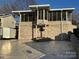 Brick house exterior with a screened porch and attached garage at 130 Badin Lake Cir, New London, NC 28127