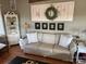 Living room with a beige sofa and rustic decor at 130 Badin Lake Cir, New London, NC 28127