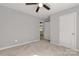 Spacious bedroom with neutral carpet and a glimpse into the adjacent kitchen, offering comfort at 1345 Mack Dr, McConnells, SC 29726