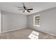 Bedroom with neutral carpeting, a ceiling fan, and a bright window at 1345 Mack Dr, McConnells, SC 29726