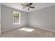 Bright bedroom with neutral carpet, ceiling fan, and a sunlit window providing a cozy space at 1345 Mack Dr, McConnells, SC 29726