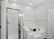 Bright bathroom features a glass enclosed shower and a large soaking tub at 141 N Arcadian Way, Mooresville, NC 28117