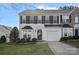 Charming townhome with a one-car garage, neat landscaping, and classic black and white facade at 141 N Arcadian Way, Mooresville, NC 28117