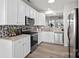 Modern kitchen with stainless steel appliances, granite countertops, and stylish backsplash at 141 N Arcadian Way, Mooresville, NC 28117