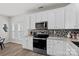 Well-lit kitchen with stainless steel appliances, granite countertops, and white cabinets at 141 N Arcadian Way, Mooresville, NC 28117