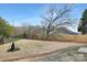 Newly fenced backyard with a large tree, fresh landscaping, and a spacious, leveled lawn at 14309 King Eider Dr, Charlotte, NC 28273