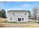 View of the home's rear exterior, showing a sliding glass door that opens to the backyard and lawn at 14309 King Eider Dr, Charlotte, NC 28273