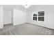 Minimal bedroom with carpet, window and walk-in closet at 14309 King Eider Dr, Charlotte, NC 28273