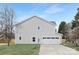 Side view of a light gray house featuring an attached two-car garage and well-maintained lawn at 14309 King Eider Dr, Charlotte, NC 28273