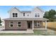 Charming two-story home showcasing a blend of grey siding and brick with a well-manicured lawn at 14309 King Eider Dr, Charlotte, NC 28273