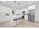 Bright kitchen with a center island, stainless steel appliances, pendant lighting, and white cabinetry at 14309 King Eider Dr, Charlotte, NC 28273