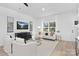 Comfortable living room featuring a large window, modern decor, and light wood flooring at 14309 King Eider Dr, Charlotte, NC 28273