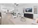 Bright living room with modern furniture, light wood floors, and a view into the kitchen at 14309 King Eider Dr, Charlotte, NC 28273