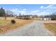 Gray mobile home with wrap-around porch and detached garage at 15918 Big Bear Rd, Albemarle, NC 28001